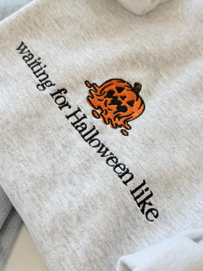 A close-up of a light gray sweatshirt shows embroidered text "waiting for Halloween like" next to a melting jack-o'-lantern design.