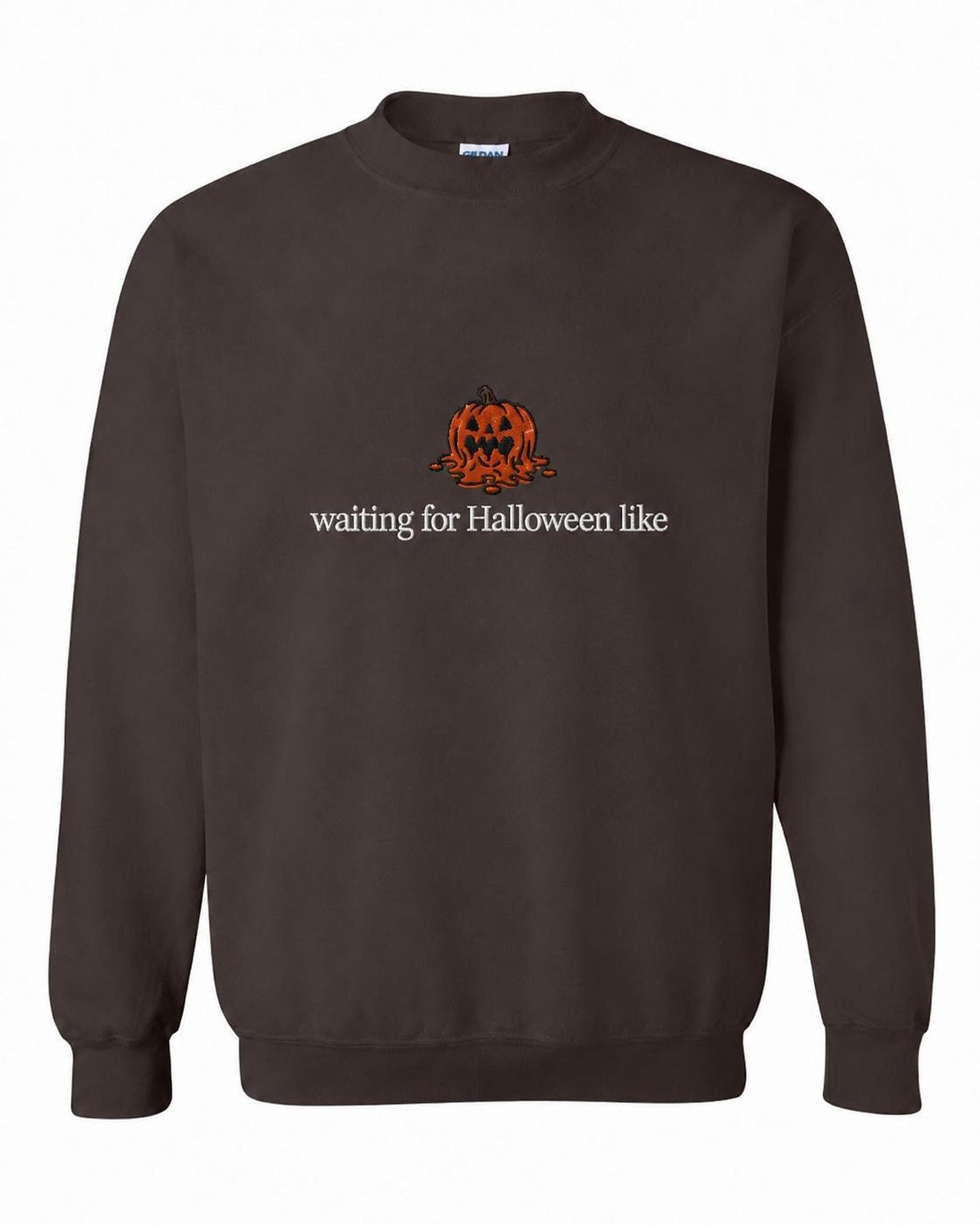 A dark brown crewneck sweatshirt with a melted orange jack-o'-lantern and the text "waiting for Halloween like" printed on the front.
