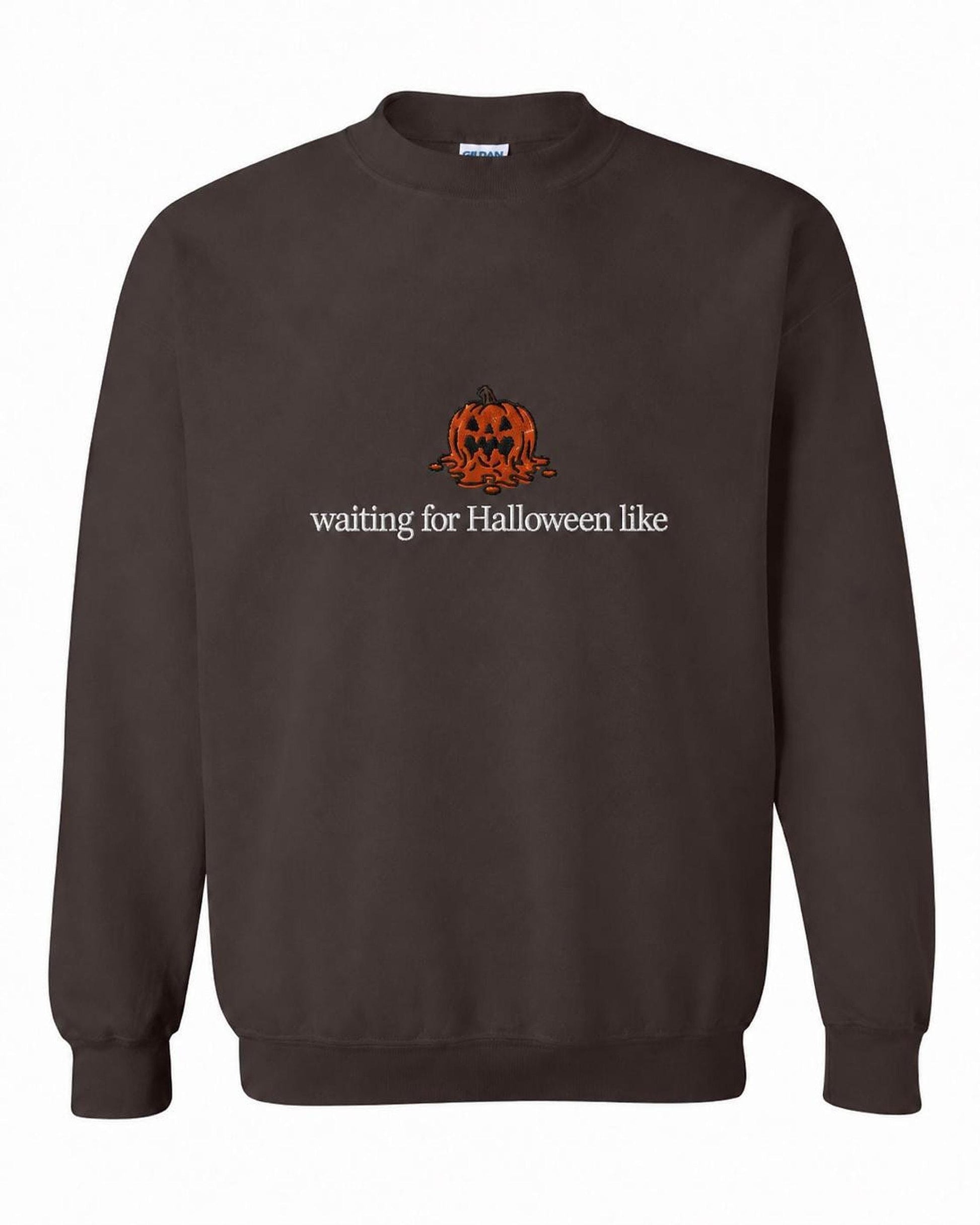 A dark brown crewneck sweatshirt with a melted orange jack-o'-lantern and the text "waiting for Halloween like" printed on the front.