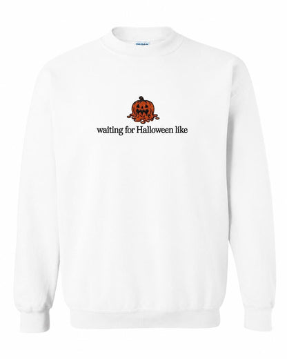 A white crewneck sweatshirt with a melted orange jack-o'-lantern and the text "waiting for Halloween like" printed on the front.
