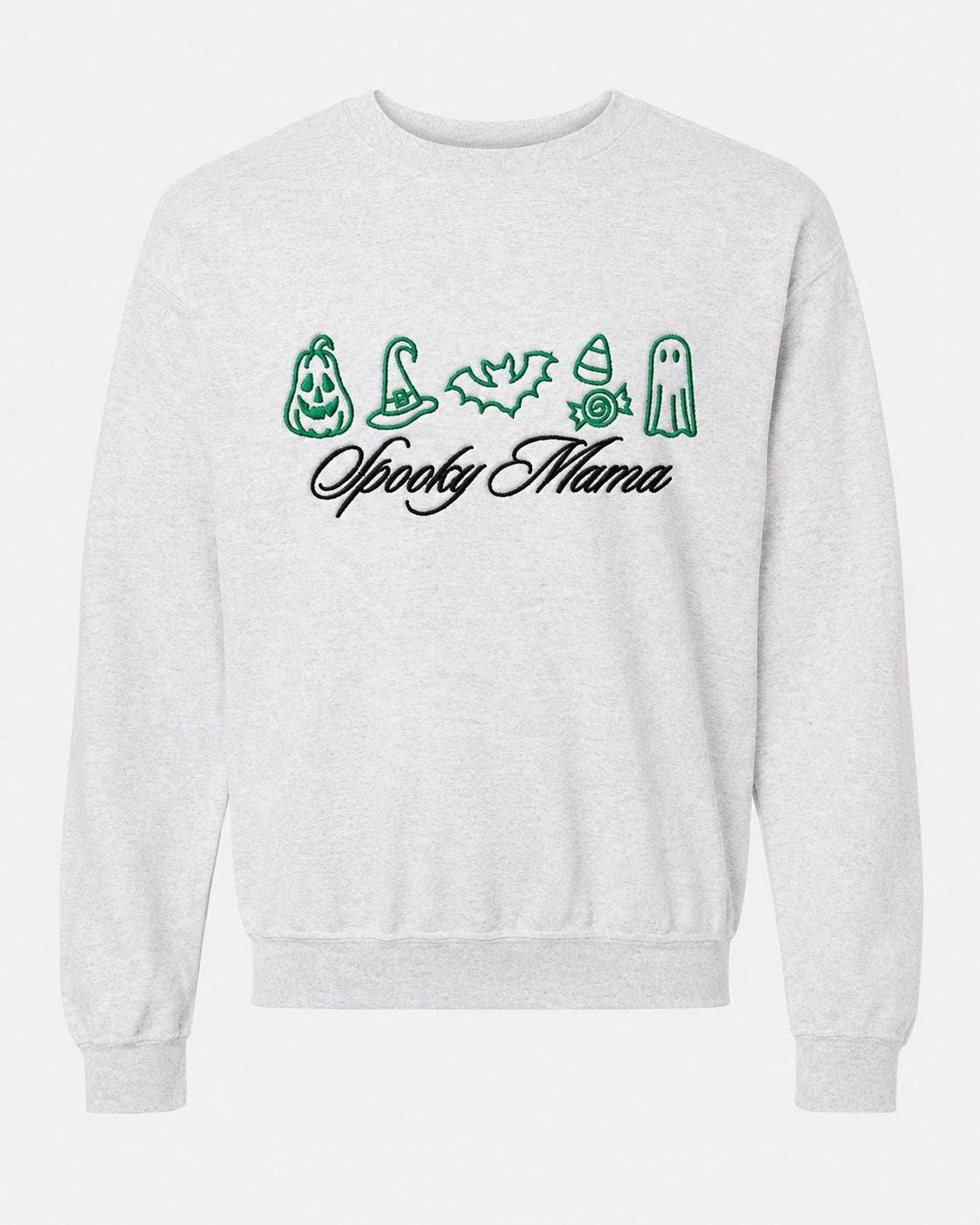 A light gray crewneck sweatshirt with green embroidered Halloween icons and "Spooky Mama" in black script, displayed flat against a white background.