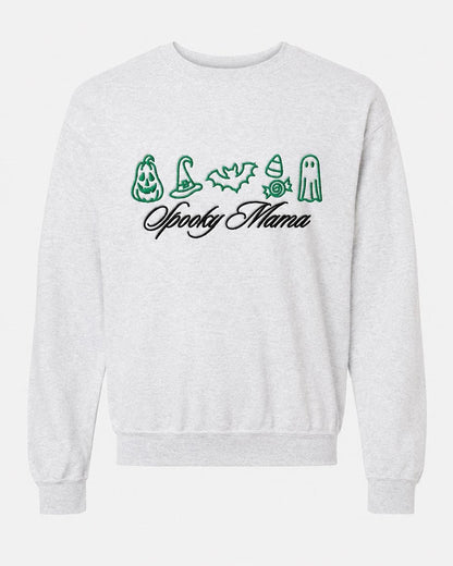 A light gray crewneck sweatshirt with green embroidered Halloween icons and "Spooky Mama" in black script, displayed flat against a white background.