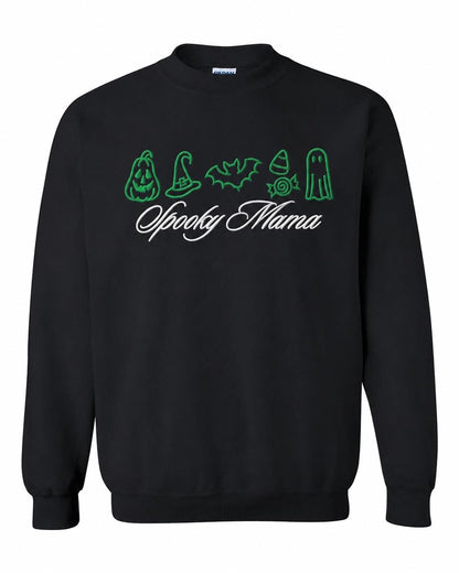A black crewneck sweatshirt with green embroidered Halloween icons and "Spooky Mama" in white script, displayed flat against a white background.