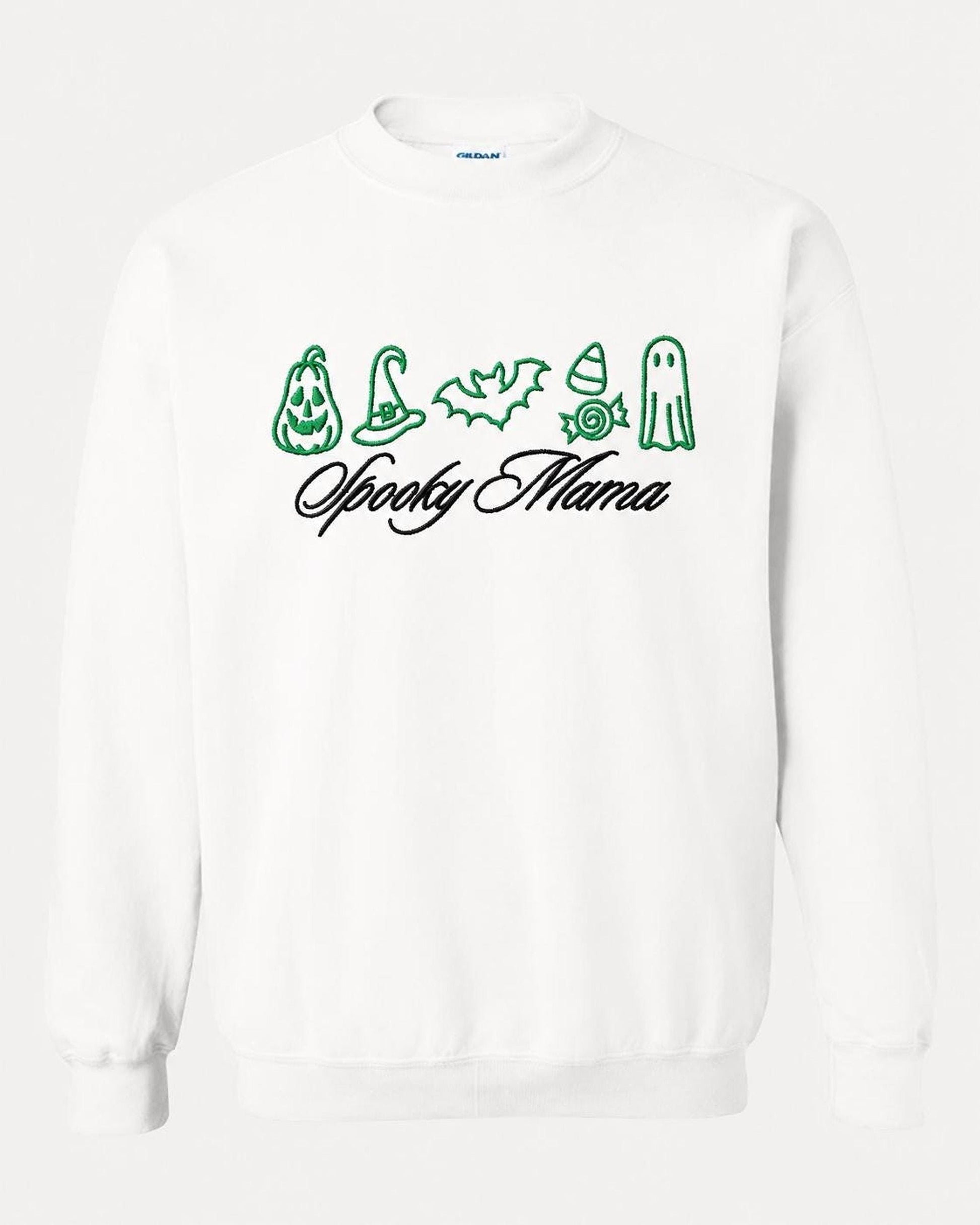 A white crewneck sweatshirt with green embroidered Halloween icons and "Spooky Mama" in black script, displayed flat against a white background.